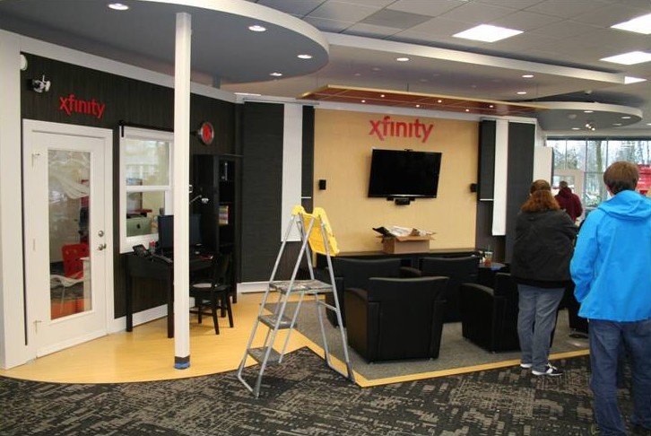 Modern Retail Store Fixtures - Xfinity display that engages customers with television, furniture and retail display fixtures