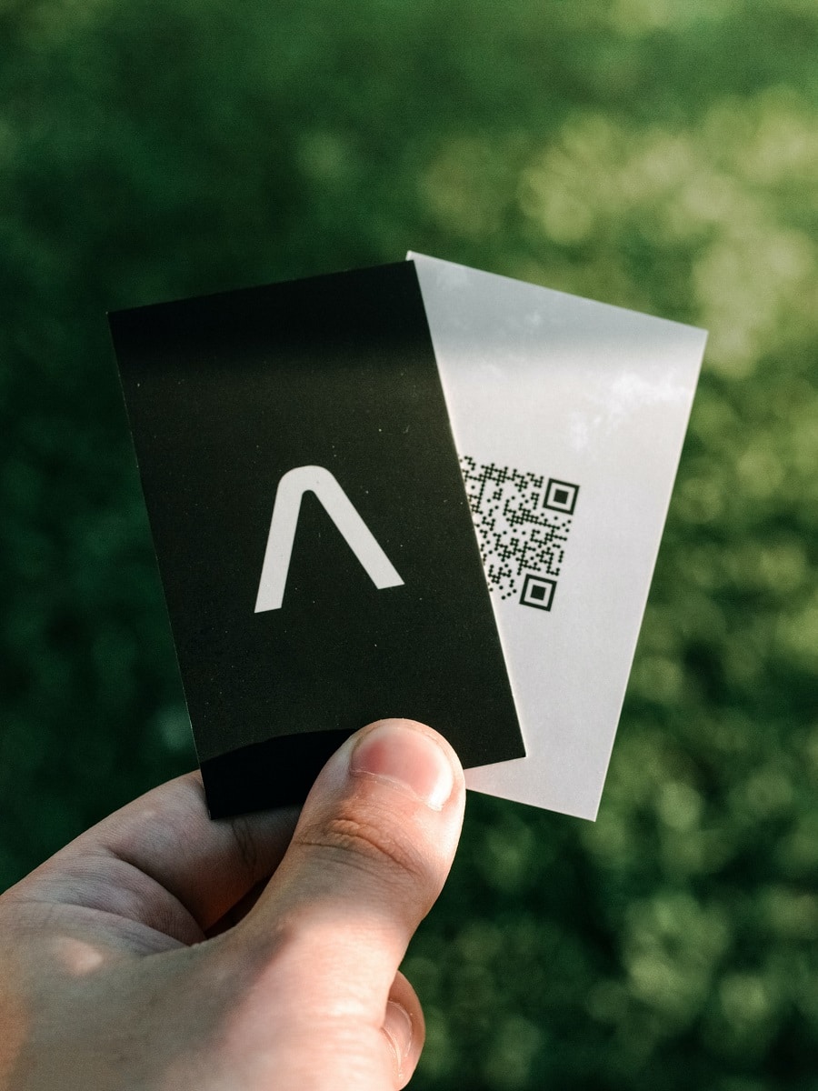 man holding business card with qr code